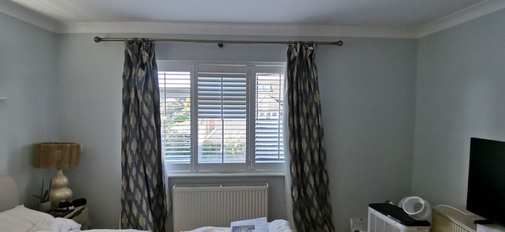 Curtain rail fitted and curtains hung on a window