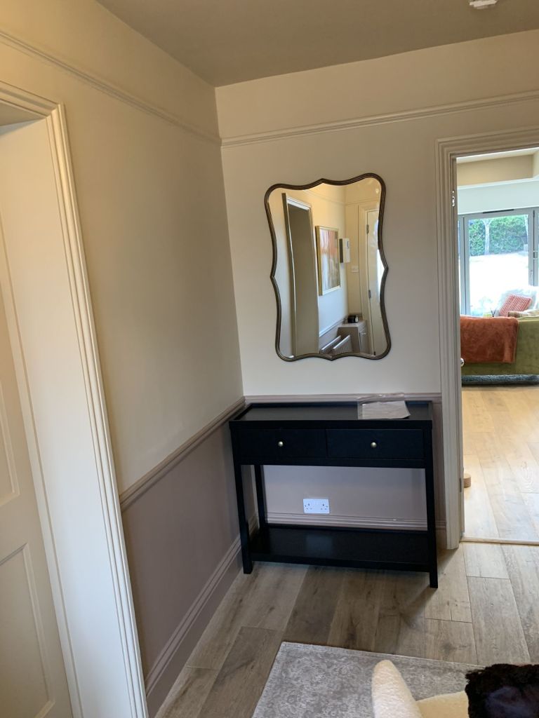 Console table assembled with a mirror hung above it